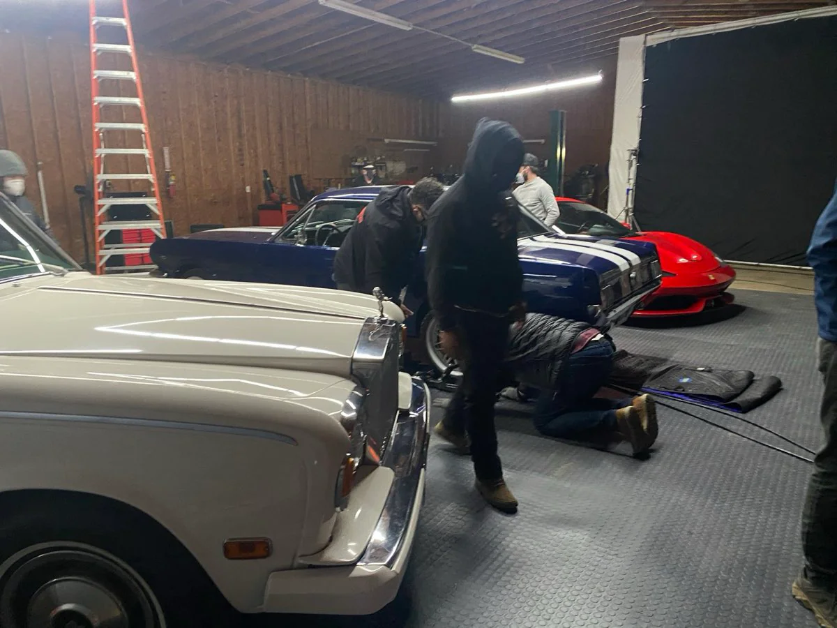 Vintage Rolls-Royce and classic muscle cars in a picture-car garage